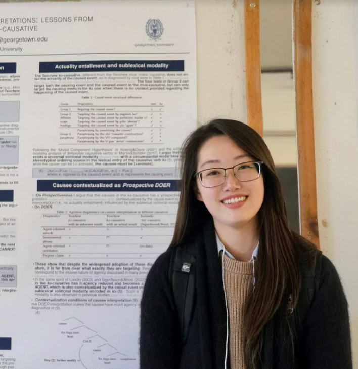 Zhuosi in front of a poster presentation