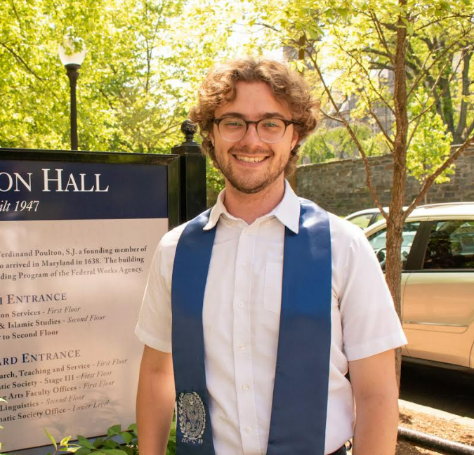 Calvin standing in front of Poulton Hall