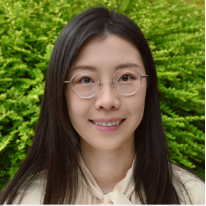 This is a portrait of Dr. JDanni Shi, who is a young, Asian woman with long black hair. She is wearing a white shirt. 